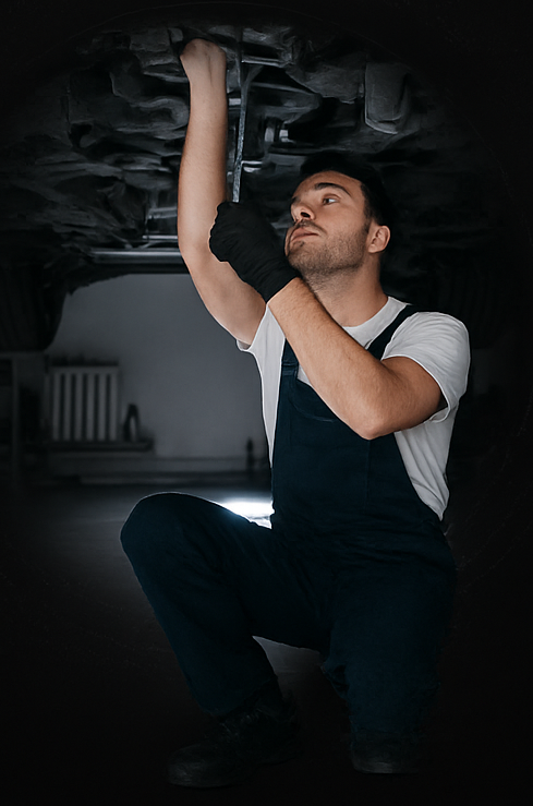 Mechanic working under car